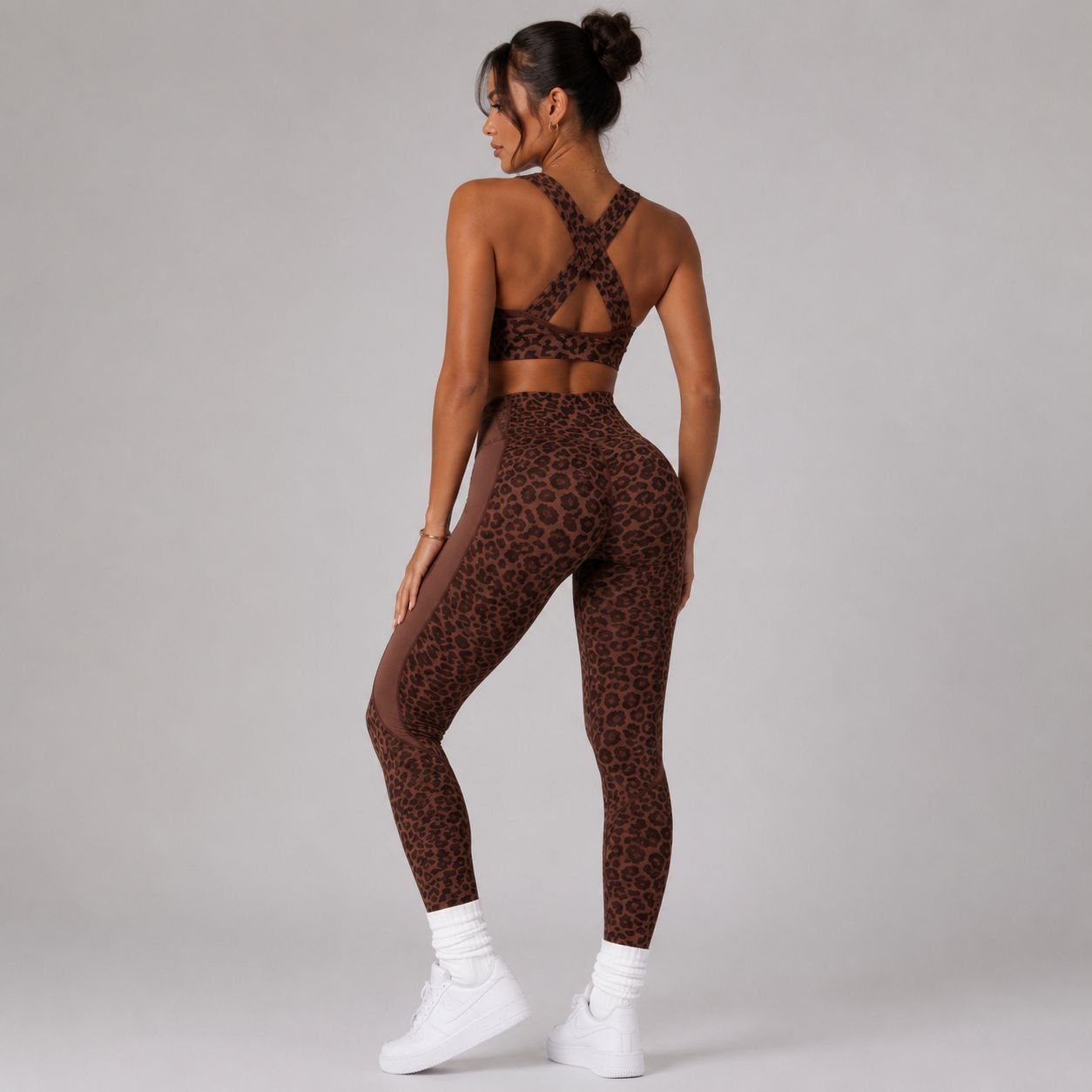 Back view of the Coffee Bean Animal Instincts Cougar Set showing the cross-back sports bra and high-waisted leopard leggings